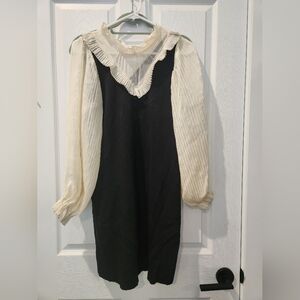 bohme black dress with gauze sleeves and high collar.